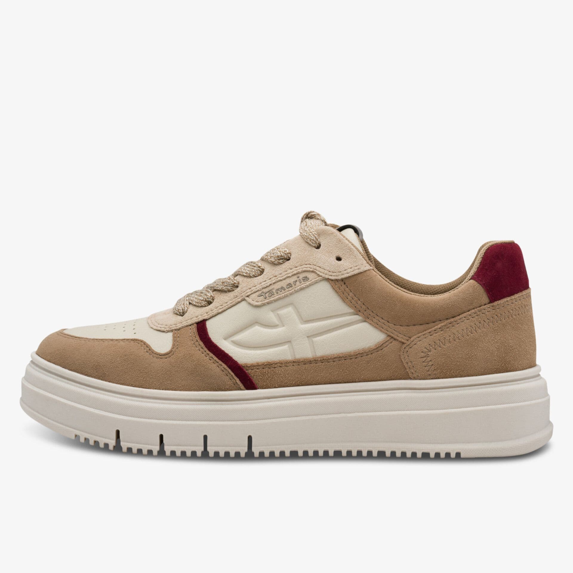 A beige and cream sneaker with a thick sole, red accents, and textured suede details on a white background.