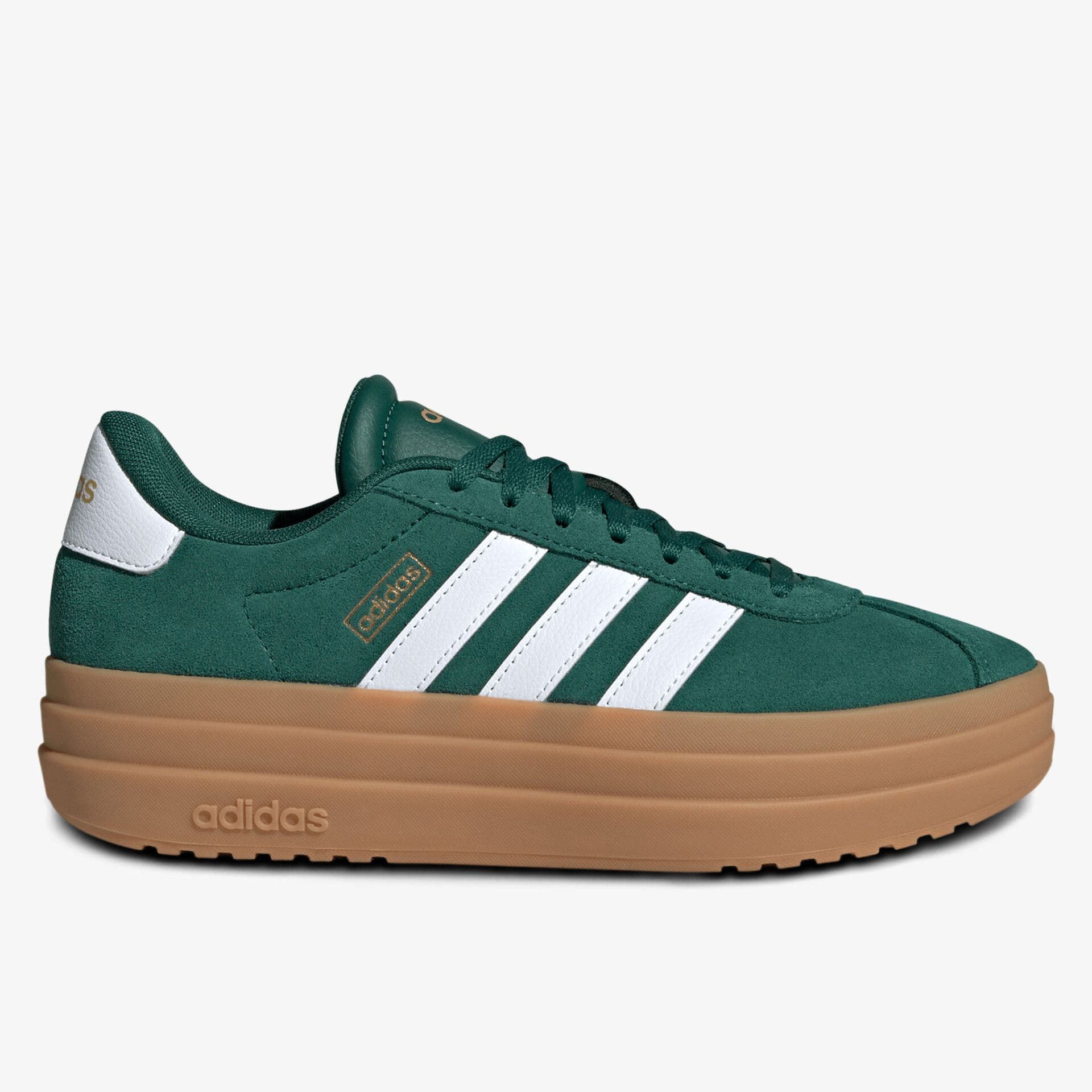 Green Adidas sneaker with white stripes, gold logo details, and a thick tan sole, set against a plain white background.
